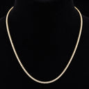 Gold necklace on a black mannequin