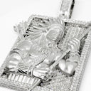 Silver pendant with intricate designs on a white background