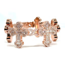 Rose gold bracelet with cross designs on a white background
